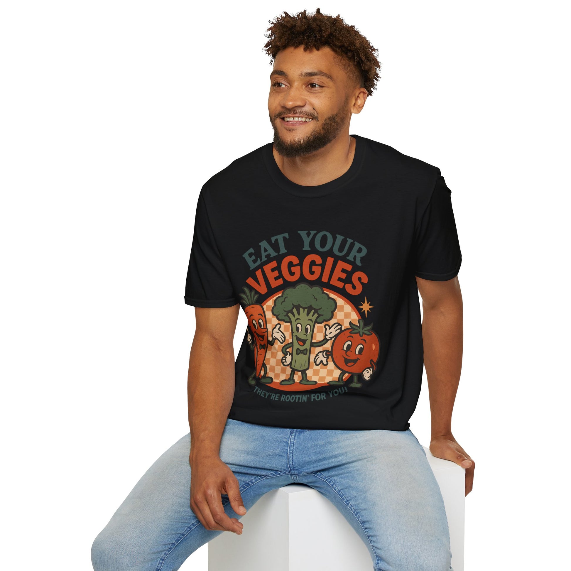 Man smiling while wearing a funny black veggie t-shirt with a retro cartoon of a carrot, broccoli, and tomato. A great vegan vegetable tee for plant-based advocates.