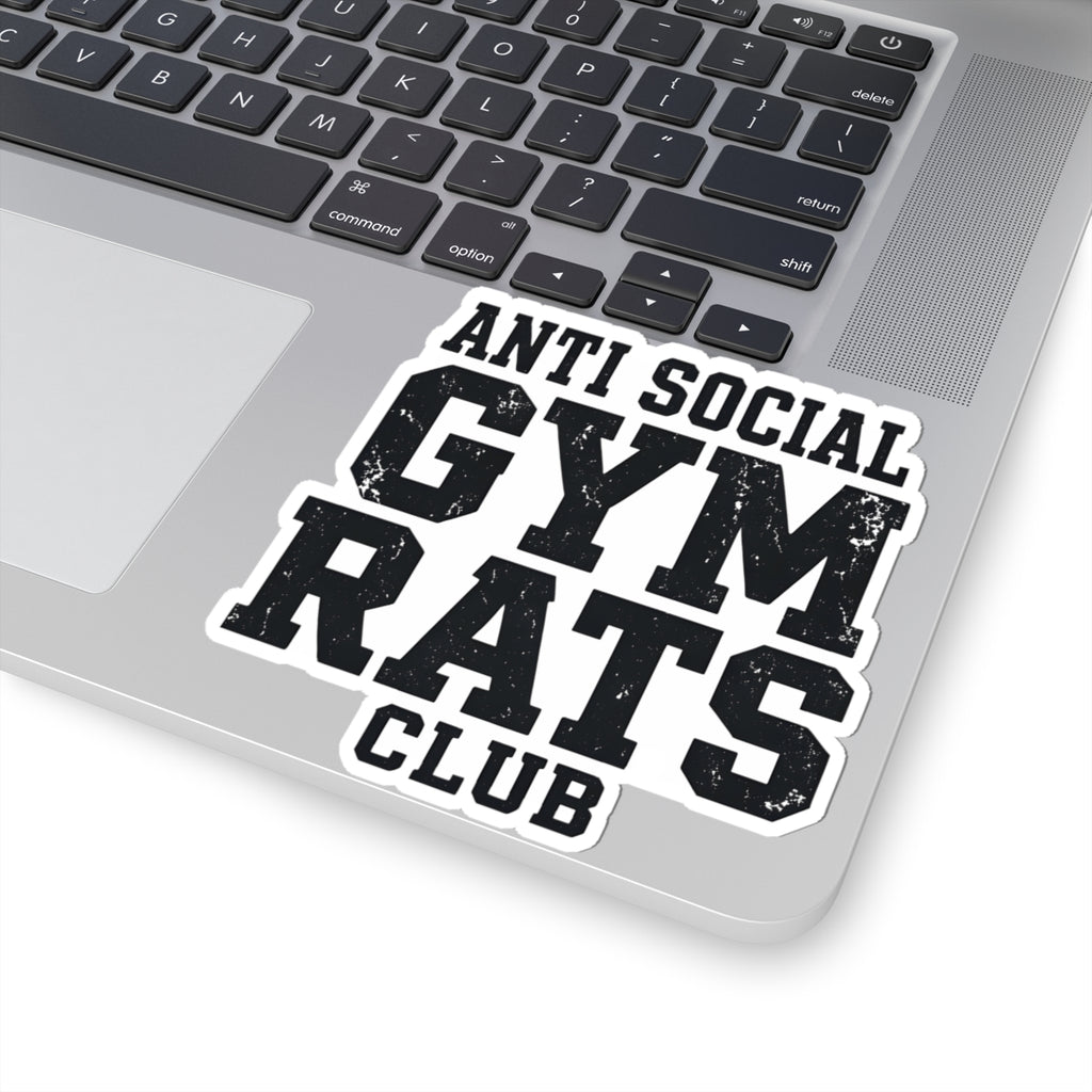 A kiss-cut vinyl sticker with the text 'ANTI SOCIAL GYM RATS CLUB' in distressed black lettering on a white background, shown applied to the silver palm rest of a laptop keyboard.