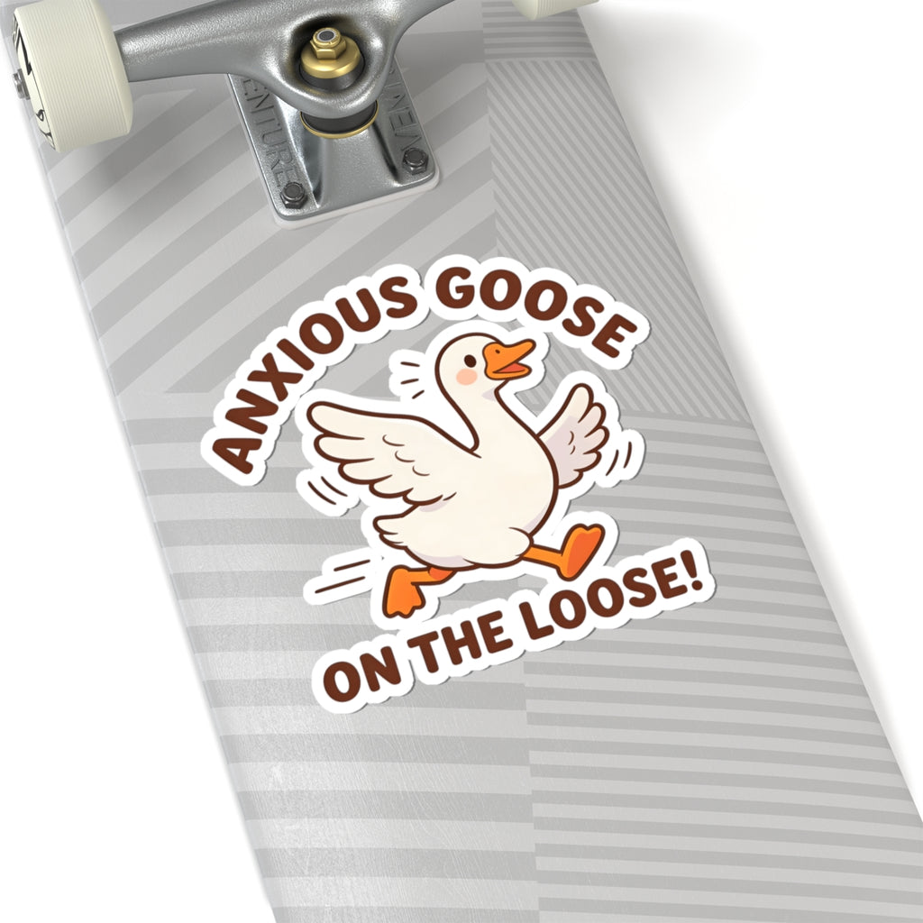 A kiss-cut sticker featuring a cartoon anxious goose with the text 'ANXIOUS GOOSE ON THE LOOSE!' applied to the tail of a skateboard with a gray and white striped deck.