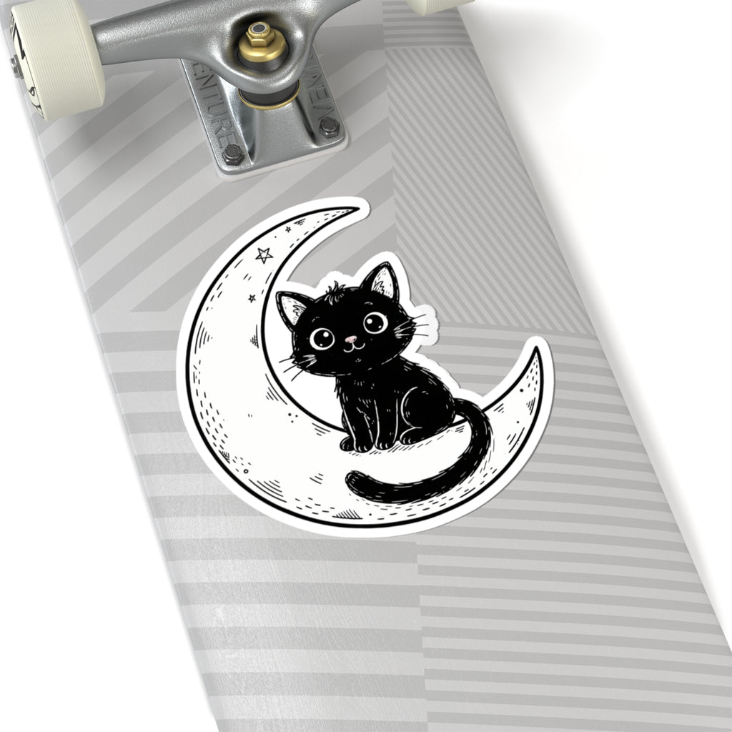 A kiss-cut sticker featuring a black cat sitting on a crescent moon, shown applied to the deck of a skateboard with a gray and white striped pattern.