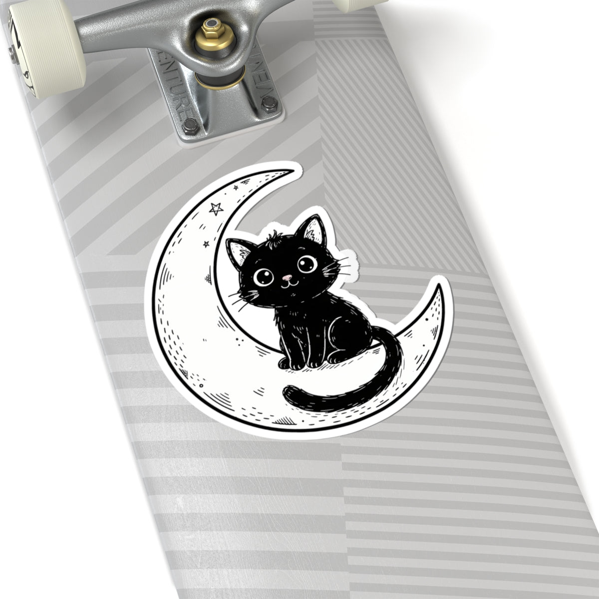 A kiss-cut sticker featuring a black cat sitting on a crescent moon, shown applied to the deck of a skateboard with a gray and white striped pattern.