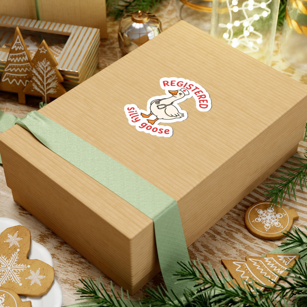 Wooden gift box with a decorative goose sticker featuring the 'REGISTERED SILLY GOOSE' on a festive background with cookies and lights.