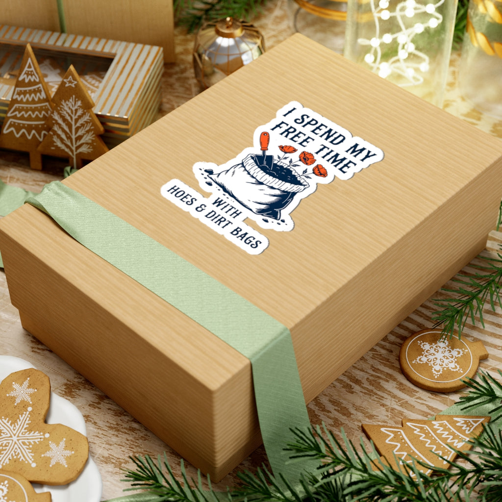 Wooden gift box with a funny garden themed sticker on a festive background with cookies and greenery.
