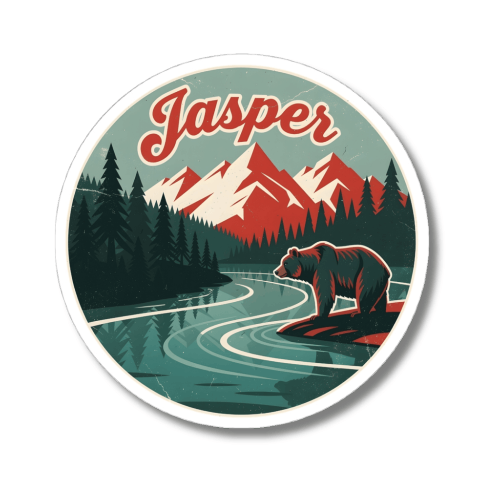 A circular sticker featuring a retro-style illustrated mountain landscape with the word 'Jasper' in red script at the top. The design shows dark green pine trees, red and white mountains, a winding teal river, and a brown bear standing on a rock in the foreground.