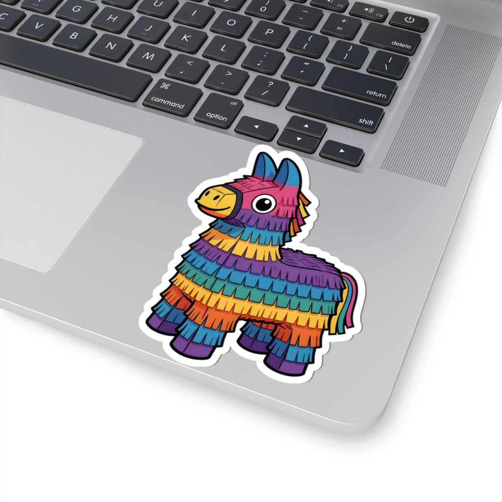 A colorful donkey-shaped pinata sticker with a rainbow fringe pattern is shown on the corner of a silver laptop keyboard.