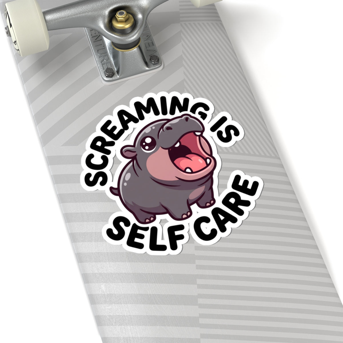 A kiss-cut vinyl sticker featuring a cartoon hippo and the text 'SCREAMING IS SELF CARE' applied to the side of a skateboard deck.