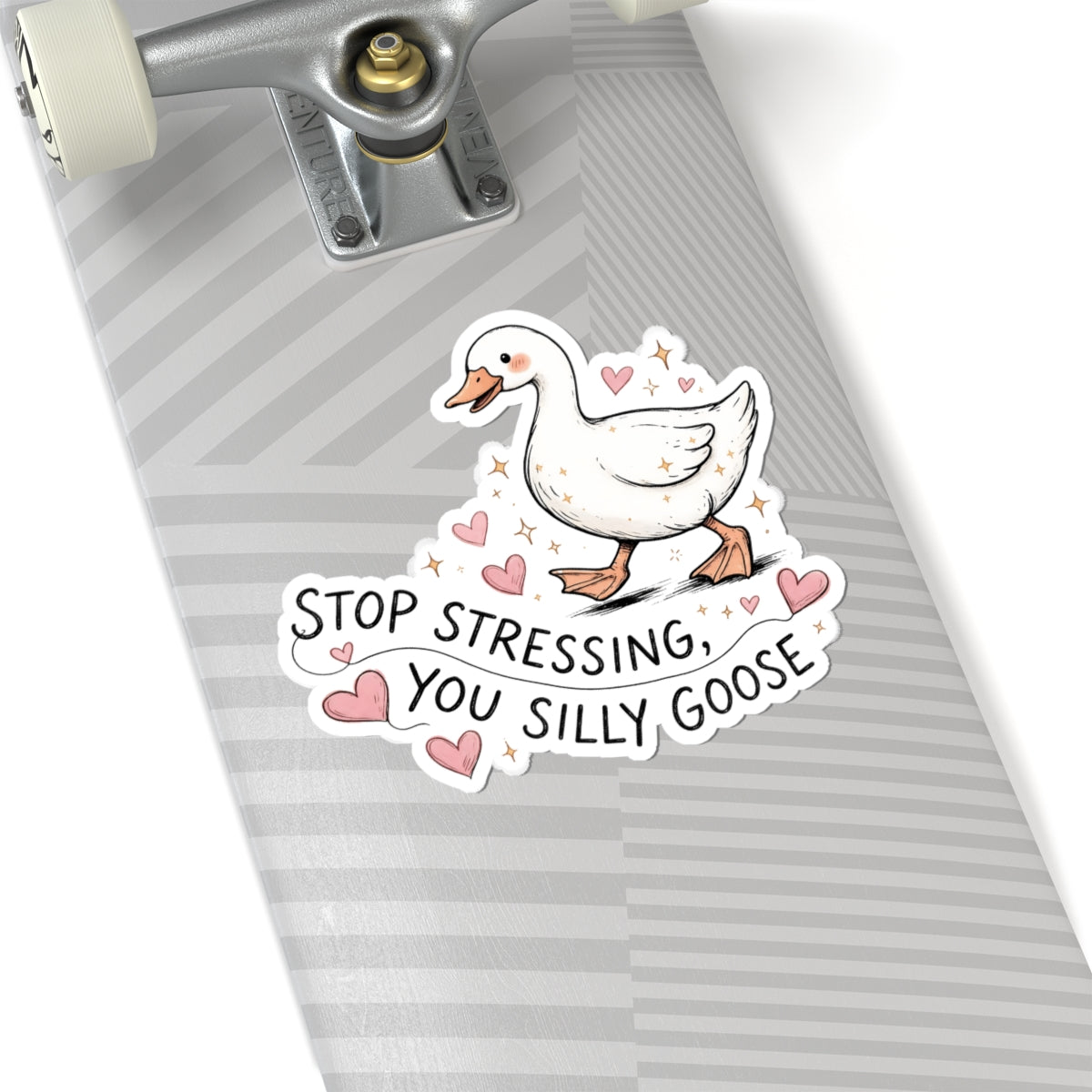 A kiss-cut sticker featuring a white goose with pink hearts and the text 'STOP STRESSING, YOU SILLY GOOSE' applied to the underside of a skateboard with a gray and white striped grip tape pattern.