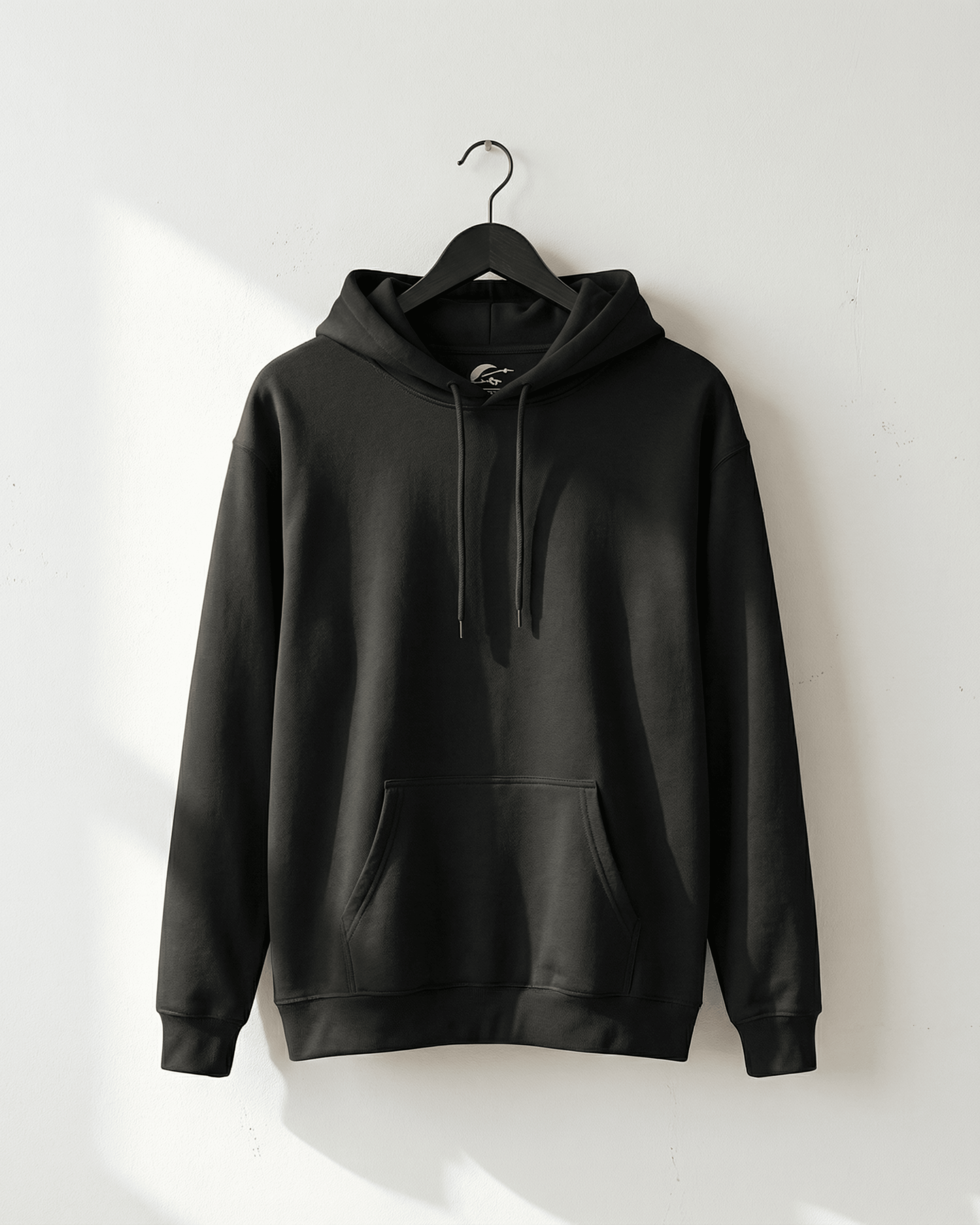 Front view of the black Chalk Dirty To Me Hooded Sweatshirt on a hanger. The hoodie has a blank front, a spacious kangaroo pocket, and a comfortable hood with drawstrings.
