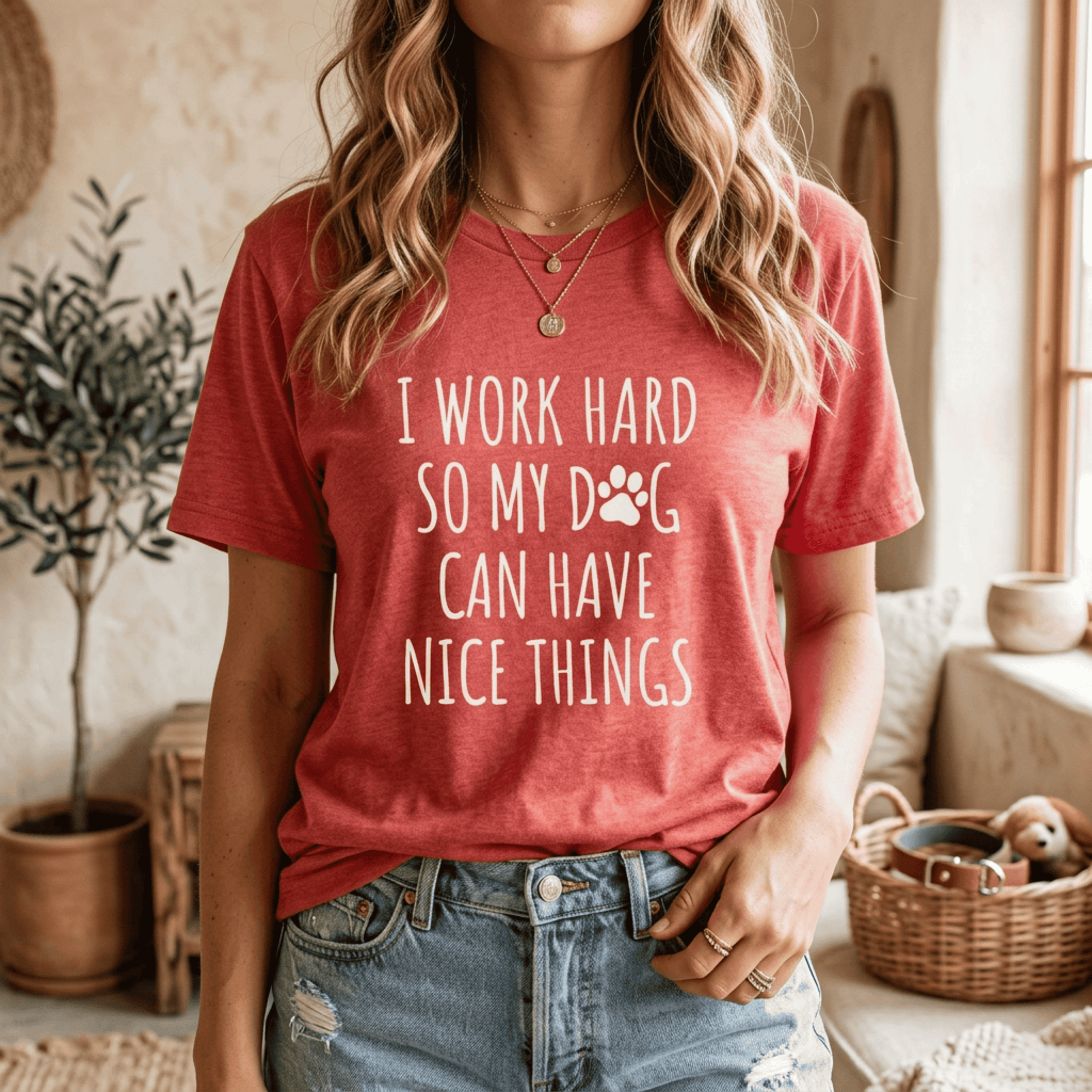Heather red Dog Lover T-Shirt modeled in a casual setting, displaying the humorous phrase "I Work Hard So My Dog Can Have Nice Things" in white typography with a dog paw icon.