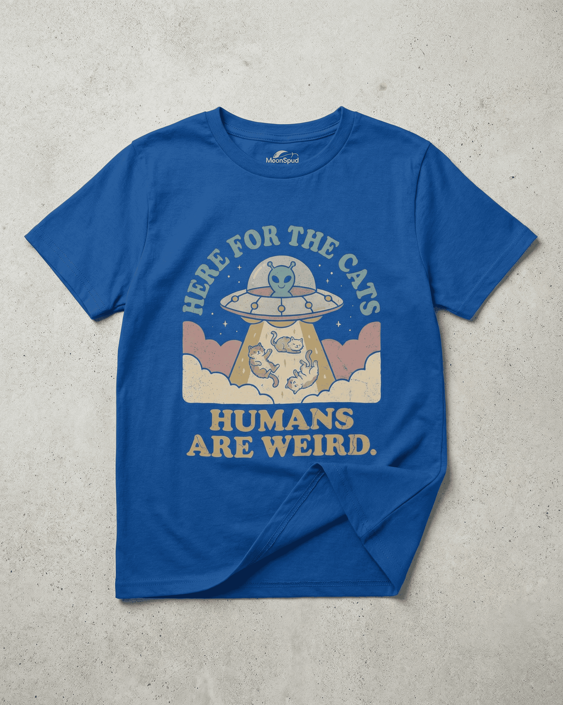 A royal blue kids graphic tee with a funny alien and cat design. The "Humans Are Weird" shirt shows a UFO with the text "Here for the Cats," perfect for a cute kids outfit.