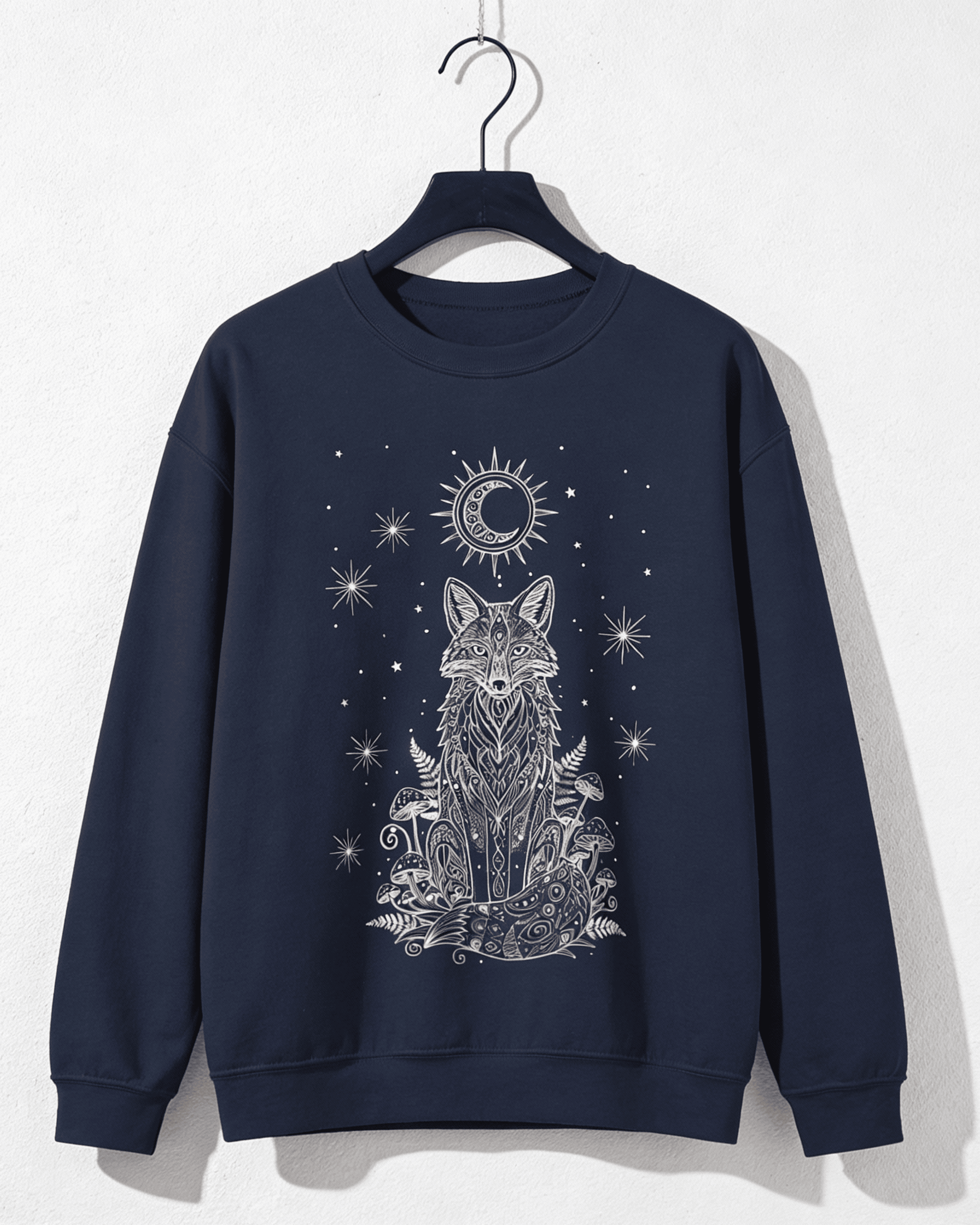 A clear product shot of the navy Fox Celestial Moon Sweatshirt on a hanger against a white wall. The image provides a detailed view of the mystical crewneck pullover's intricate silver-white graphic, featuring a celestial fox, moon, and stars, embodying a witchy aesthetic.